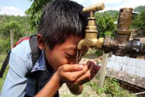 boy_drinks_from_a_tap_at_a_newah_wash_water_project_10677785345